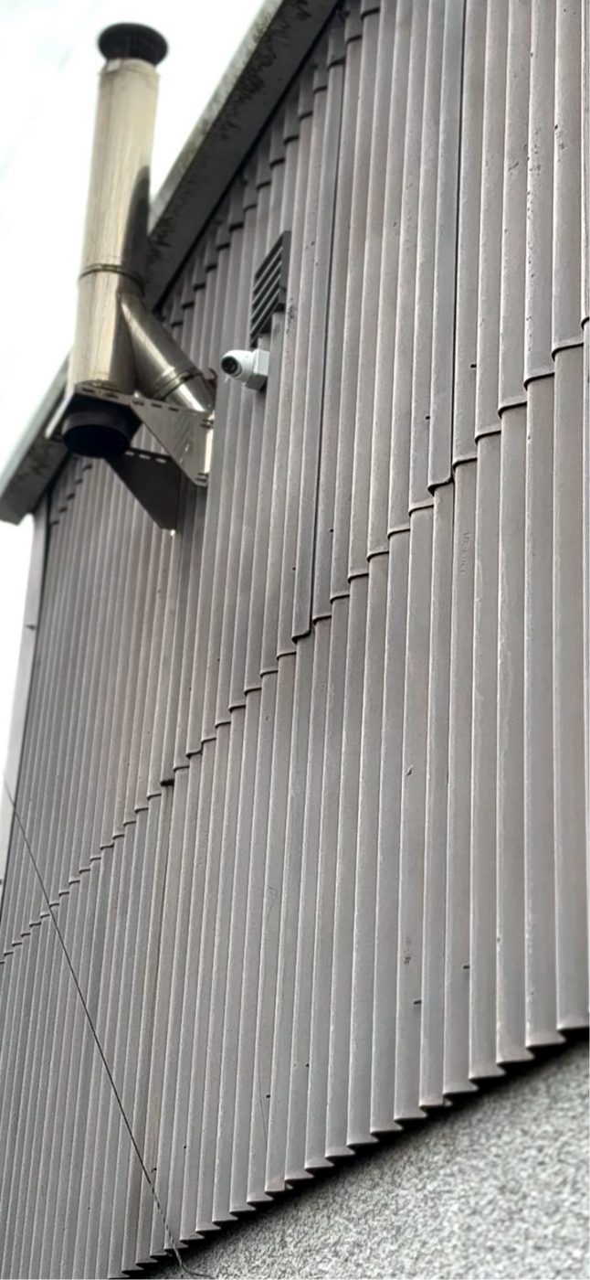 External CCTV bullet camera securely mounted to a commercial building exterior