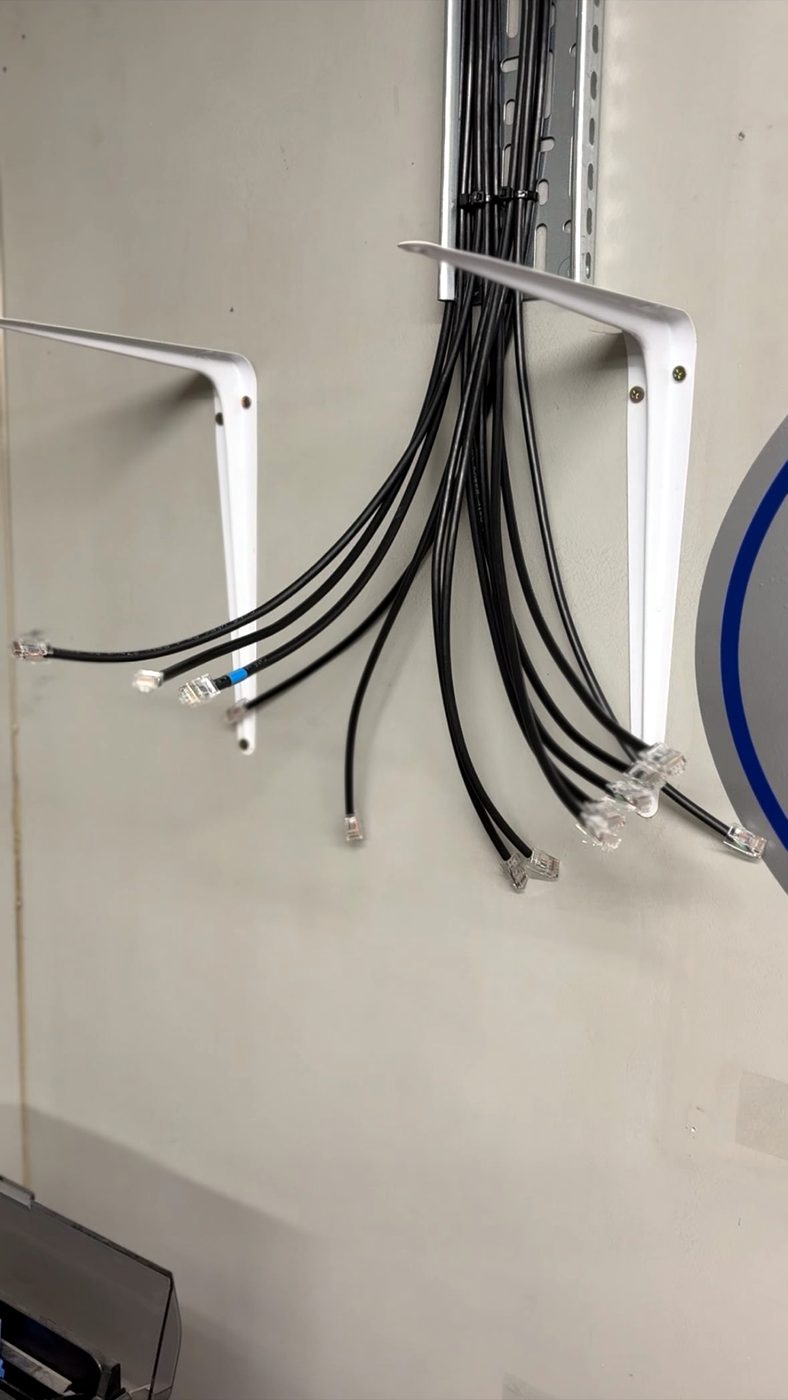 Structured network data cabling terminated and dressed onto wall containment